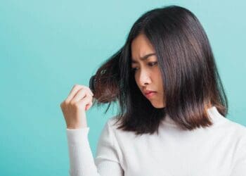 woman upset with a comb and problem hair