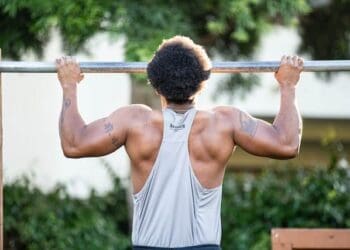 man doing pull-ups outdoors